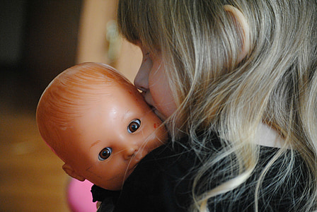 girl carrying doll thumbnail