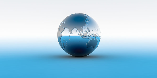 stainless steel globe on white surface thumbnail