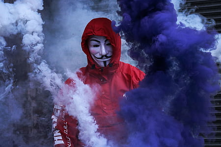 person wearing Guy Fawkes mask surrounded by smoke thumbnail