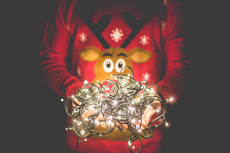 Man in Christmas Sweater Holding Christmas Lights thumbnail