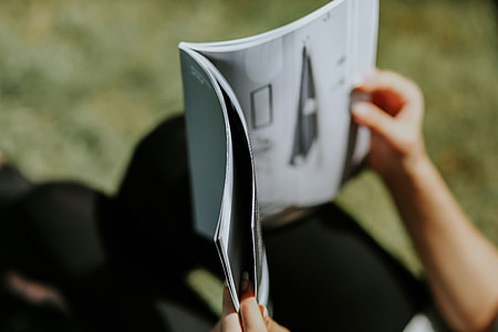 Woman reading a magazine outdoors thumbnail
