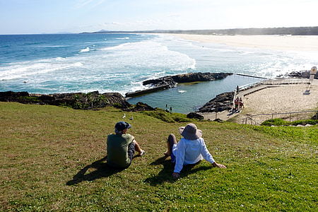 two persons sitting on green grass thumbnail