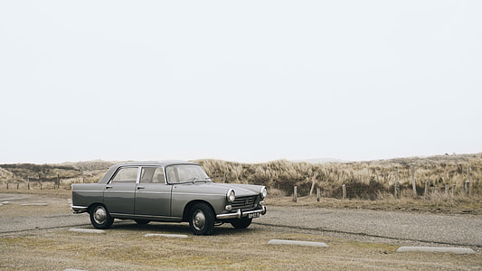 classic gray sedan on road during daytime thumbnail