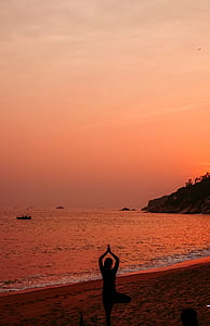 silhouette photo of woman doing yoga during sunset thumbnail