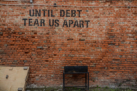 brown brick wall with until debt tear us part text thumbnail