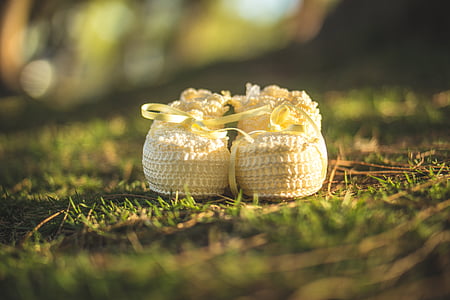 pair of baby's white shoes on grass thumbnail