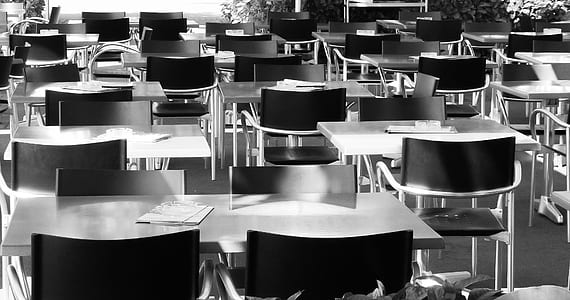 grayscale photography of empty table and chairs thumbnail