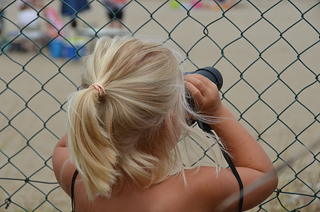 woman holding binoculars thumbnail