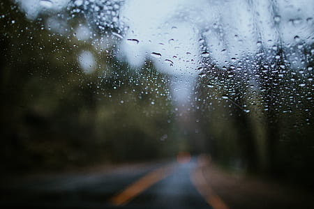 winding road view through wet glass thumbnail