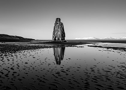 gray rock between surrounded by body of water thumbnail