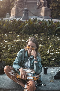 Woman Sitting on Floor With Boxes on Lap thumbnail