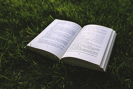 book page on green grass during daytime thumbnail