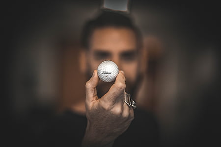 person holding golf ball thumbnail