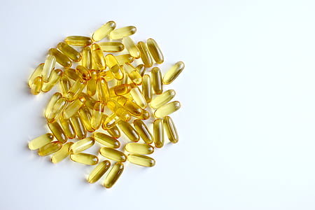 gold pills on white surface thumbnail