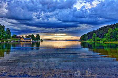 blue clouds reflected on water at daytime thumbnail