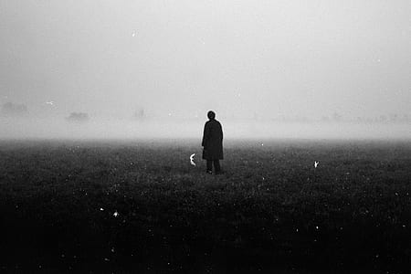 man standing on grass land thumbnail