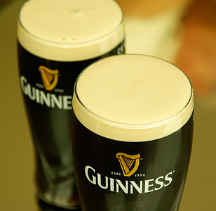 closeup photography of two Guinness pilsner glasses thumbnail