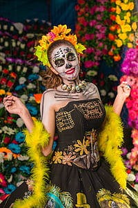 woman with face painting surrounded by assorted-color flowers thumbnail