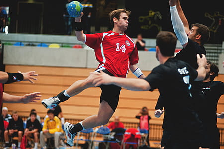 person holding blue and green ball while jumping beside in front of person thumbnail