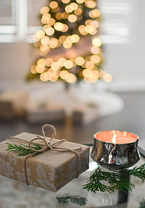Close-Up Photography of Gift Besides Candle thumbnail