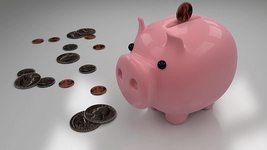 pink ceramic piggy bank with coins thumbnail