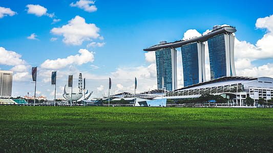 silver building under cloudy sky thumbnail