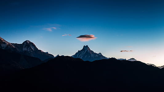 silhouette of mountain under white clouds thumbnail