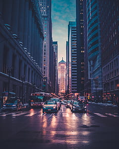 cars near concrete buildings thumbnail