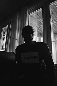 man standing near glass door thumbnail