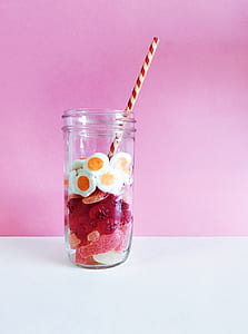 egg and pink candies in mason jar with straw thumbnail
