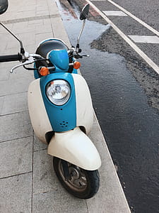 Photo of Motor Scooter Parked On Pavement thumbnail