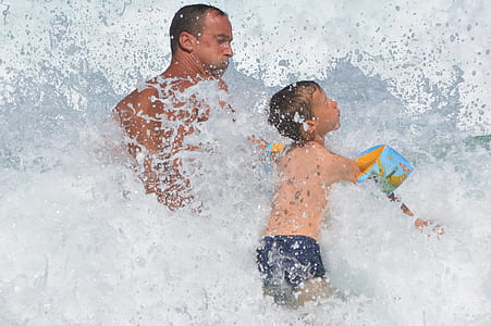 man and boy playing on beach thumbnail