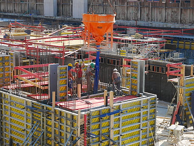 people working above yellow and red platform during daytime thumbnail