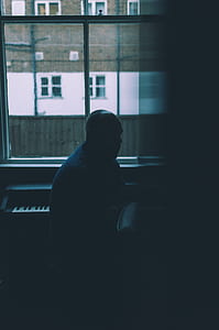 man sitting next to piano thumbnail