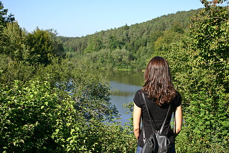woman standing surround by green plants thumbnail