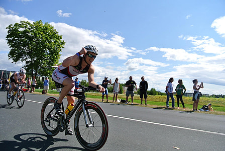 man riding bike on road thumbnail