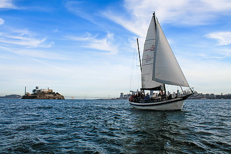 sailing boat on body of water near highrise buildings thumbnail