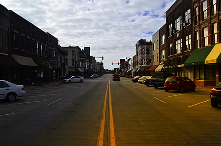 cars parked on side of street and front of buildings thumbnail