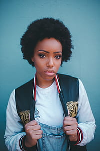 woman standing near to wall wearing black and gray jacket thumbnail