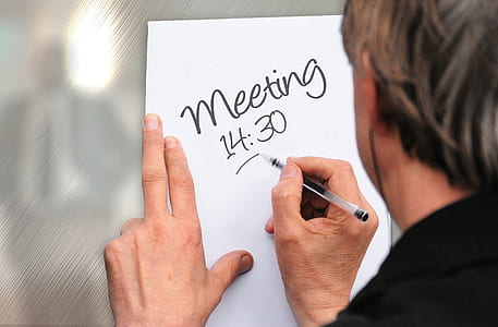 man with gray hair holding black ballpoint pen thumbnail