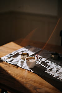 white ceramic mug on brown table thumbnail
