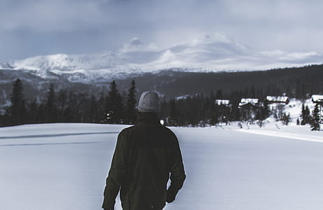 Man Wearing Black Jacket Walking in the Snow thumbnail