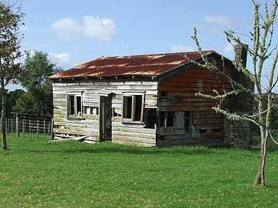 abandon house on grass field under blue and white skies thumbnail