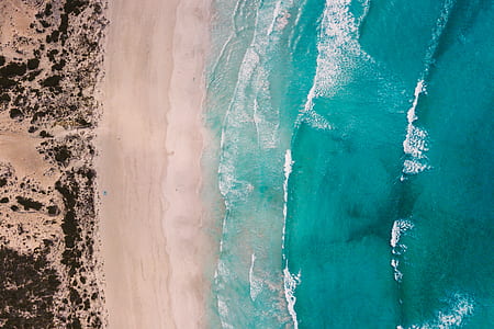 waving blue sea on white beach aerial photography thumbnail