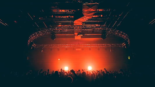 people watching concert inside black room thumbnail