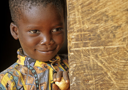 boy in yellow top against wall thumbnail