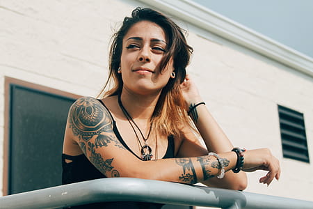 woman leaning on gray steel bar thumbnail