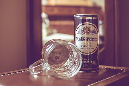 Kaiserdom Premium can beside glass beer mug on brown wood surface thumbnail