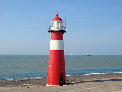 red and white lighthouse near shore thumbnail