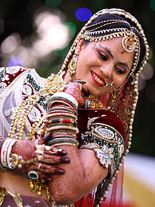 focus photography of smiling woman wearing gold-colored accessories thumbnail